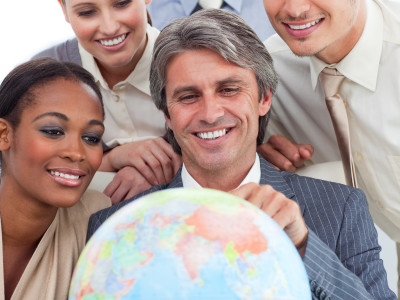 Multi-ethnic business people looking at a computer in a meeting